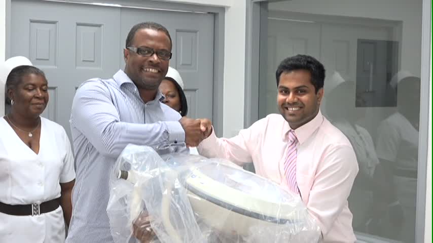 President of the MUA Student Government Vivek Govardhanam presenting the lighting equipment to Minister of Health Hon. Mark Brantley at the handing over ceremony at the Alexandra Hospital on June 12, 2015